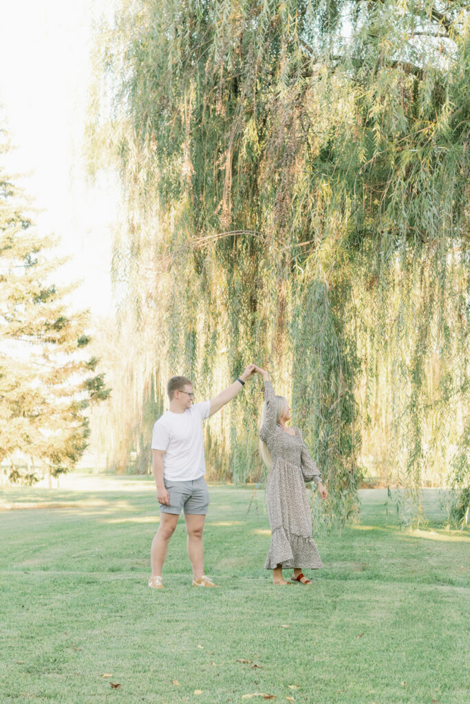 couple dances in front of willow trees in park, dayton ohio family lifestyle photographer