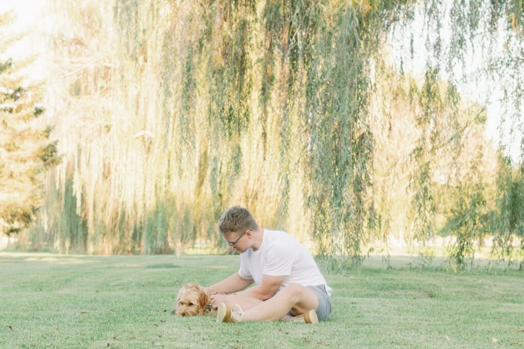 man pets dog in large green park, kyle park tipp city ohio, dayton ohio photographer 