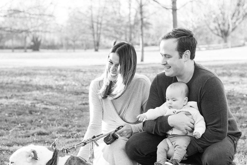 man and woman hold their infant son and english bulldog in park in dayton ohio christmas card photos 