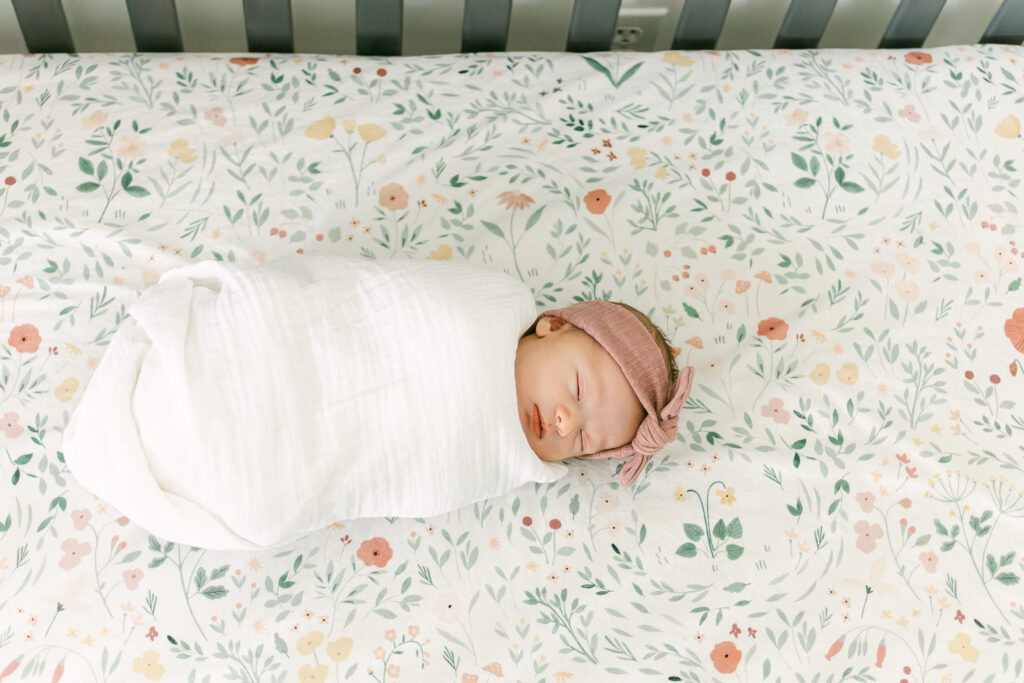 sweet newborn baby girl sleeps in crib while mariemont ohio professional photographer takes pictures 