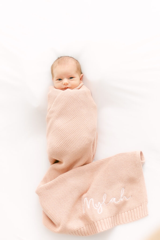 dayton ohio photographer takes picture of newborn baby girl in personalized blanket