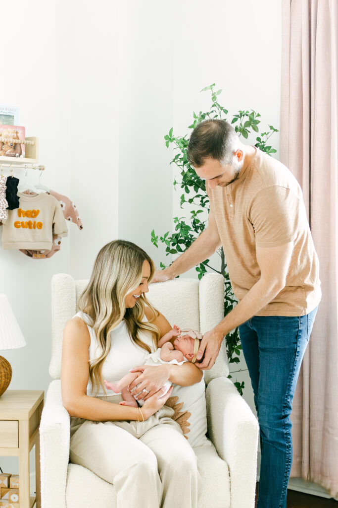 new parents hold infant daughter for professional photos in greater western ohio 