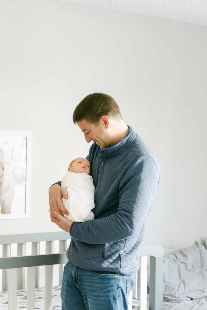 father holds newborn son for professional pictures in dayton ohio 