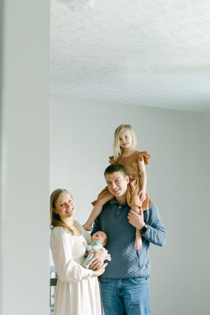 family of 4 pose for professional photos in ohio 