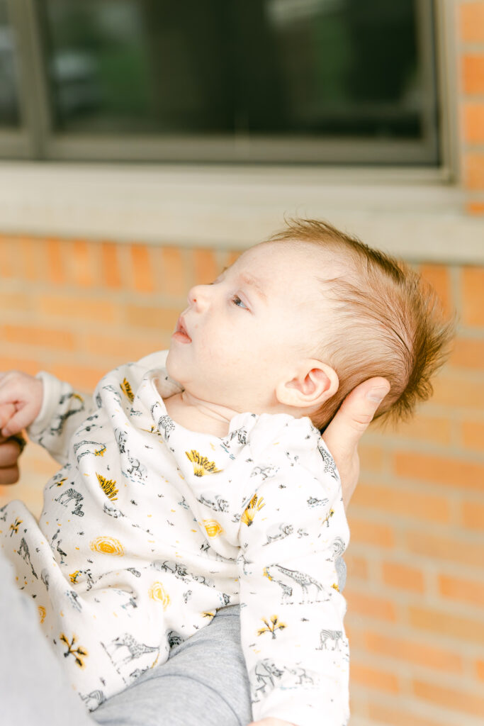 newborn infant boy held my parent as picture is taken by dayton ohio photographer