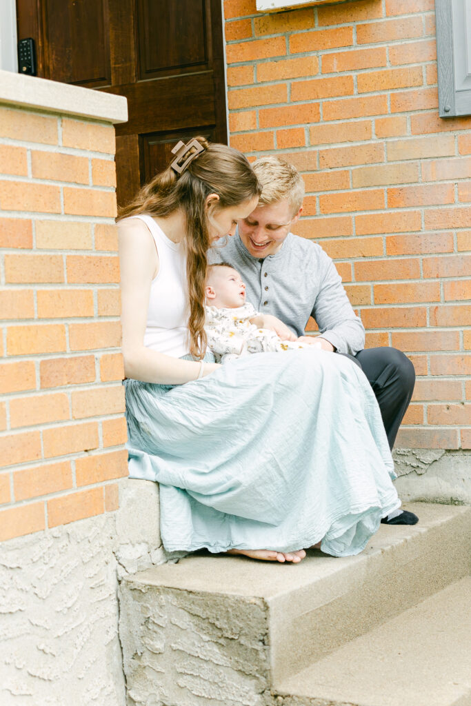 family of three pose for professional photos in dayton ohio area