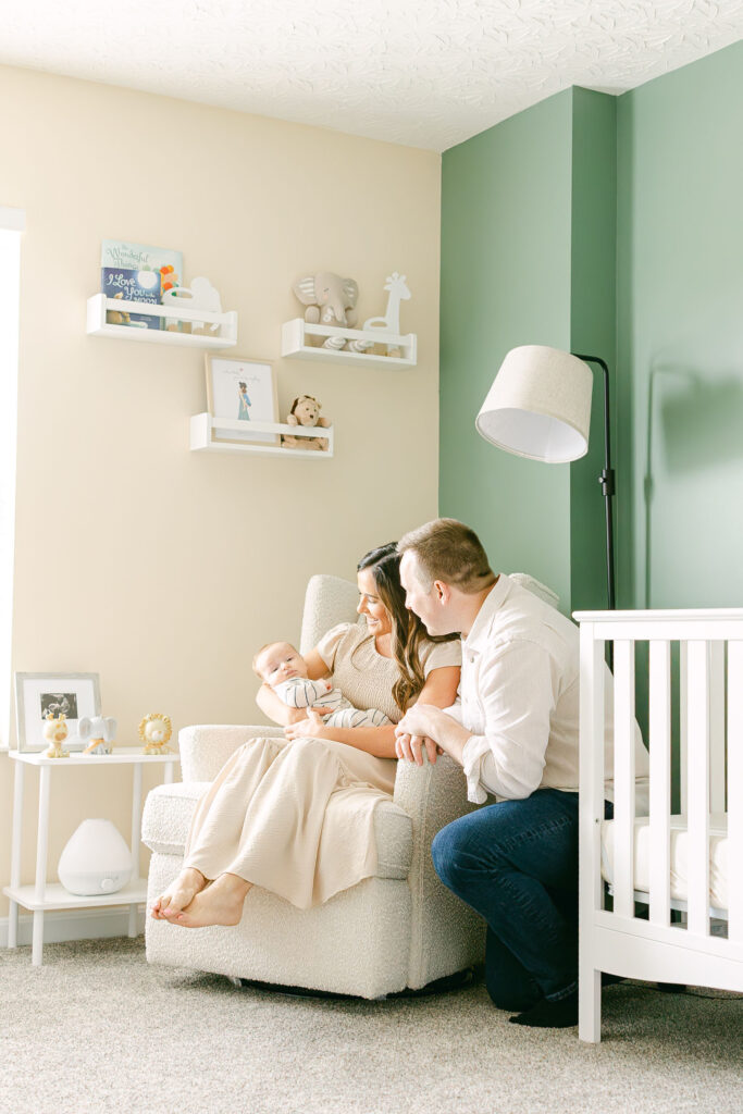 New parents holding their newborn during an in-home lifestyle newborn photography session in Dayton Ohio