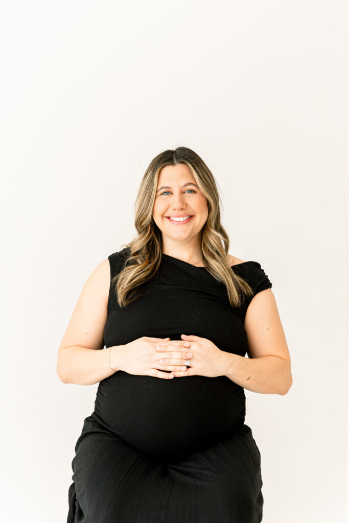 mom with both hands on baby bump for cincinnati maternity photographysession
