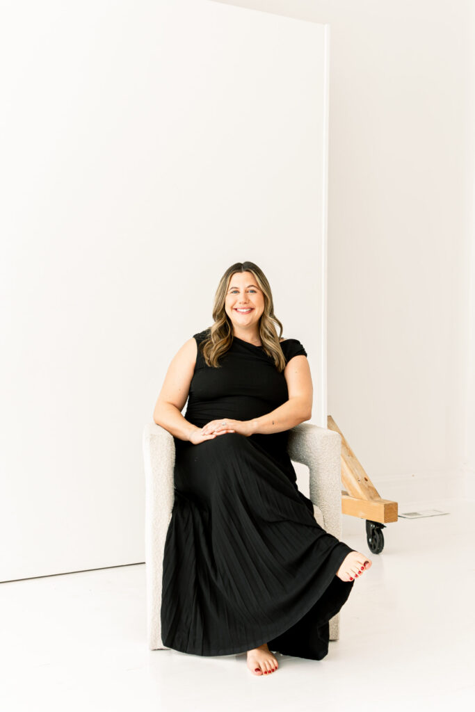 new mom smiling at the camera for cincinnati maternity photography session